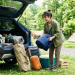 キャンプ道具を車に積み込む準備をしている様子
